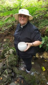 Revd Heather collecting holy water