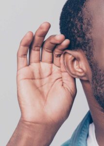 Image shows a person with their hand to their ear to signify listening. iStock image: Deagreez