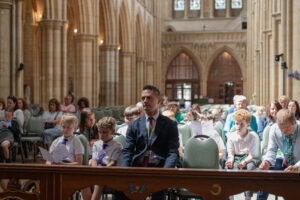 Image shows people sat in the cathedral