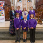 A teacher and pupils in the cathedral.