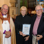 The Bishop of Truro to the left with with two others - one holding a certificate.