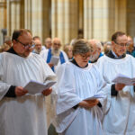 People in white singing.