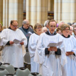 People in white singing.