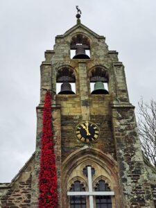 Tresillian Church with knitted poppies on it.