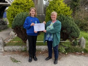A poetry winner being presented with a certificate.