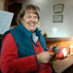 Someone cutting with red handled scissors in a church.