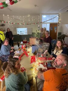 People sat around a table at Christmas time.