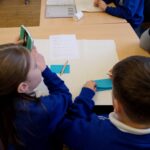 Children sat at a desk