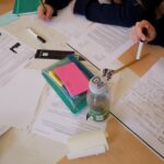 Hands, paper and writing.