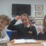 Children looking at the camera - square frames behind them.