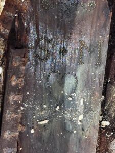 A coffin with initials on them.