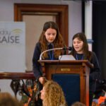 Two children speaking from the pulpit.
