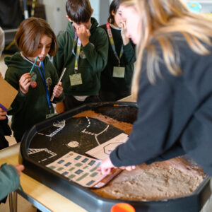 Children watching a workshop demonstration before they give it a go.