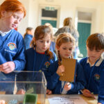 Children watching a workshop demonstration before they give it a go.