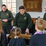 Children watching a workshop demonstration before they give it a go.