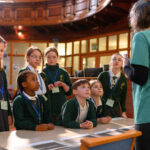 Children watching a workshop demonstration before they give it a go.