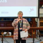 Clare Green at the front of the church speaking.